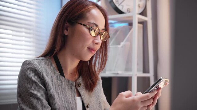 young businesswoman texting on cell phone