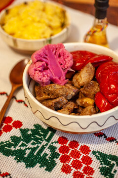 romanian traditional winter season meal with polenta mamaliga fried pork scraps and pickled vegetables