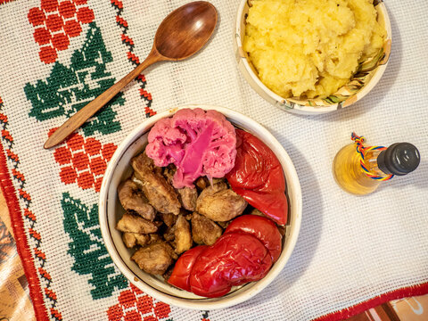 romanian traditional winter season meal with polenta mamaliga fried pork scraps and pickled vegetables