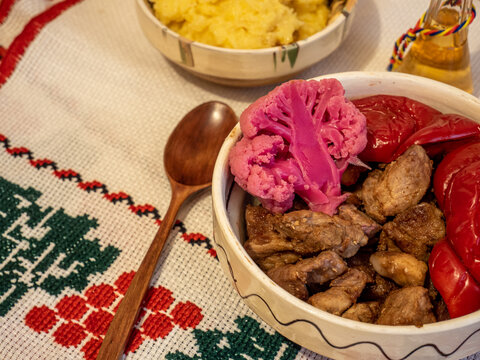 romanian traditional winter season meal with polenta mamaliga fried pork scraps and pickled vegetables