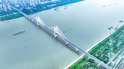 Modern Cable-Stayed Bridge Spanning River - Aerial City View © TranPhuoc