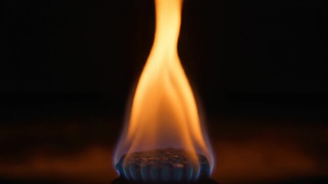 Closeup of a small flame burning on a burner