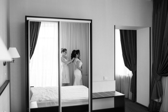 preparations for the bride with the dressing of the wedding dress