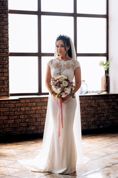 portrait of a young bride inside a restaurant agains