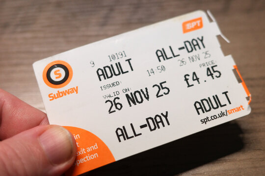 Glasgow Scotland: 31 12 2025: A person holds a Glasgow Subway smart ticket that allows all-day travel for adults. The ticket shows the issue time and price