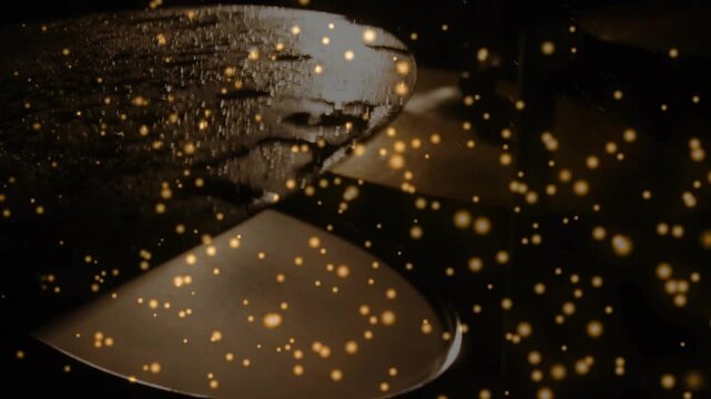 Camera shifting light sweeping metal spoons glinting droplets gold bokeh drifting over rims for ads