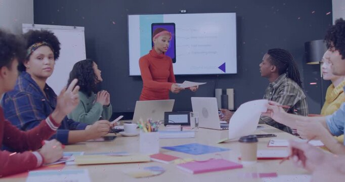 Woman presenter standing by screen starting meeting, handing handouts and guiding business review