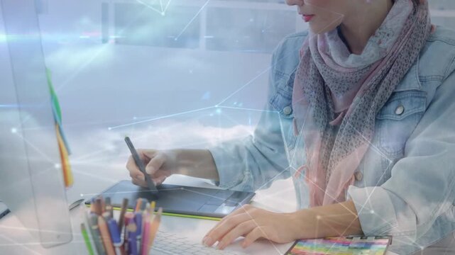 Designer drawing on tablet stylus causing cloud or network overlay camera pulling back creating art