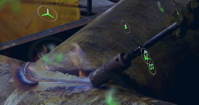 Welder igniting torch and welding seam to join pipe sections in fabrication while holograms rising