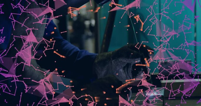 Welder feeding rod touching vise sparking arc forming weld pulling torch pink haze crossing hands