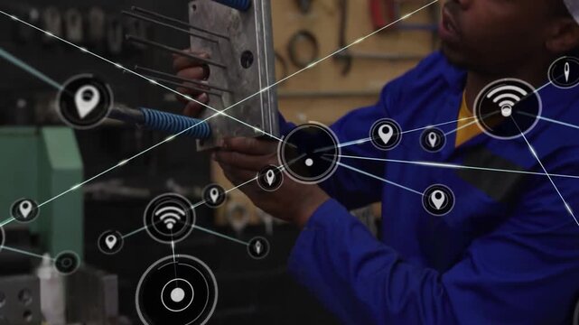 Technician aligning metal component for assembly on bench, network overlays linking around machine