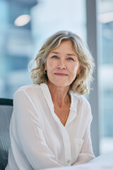 Fototapeta premium Experienced senior professional conveying trust, stability, and leadership in a modern business environment. Elderly professional in modern office, successful businesswoman.