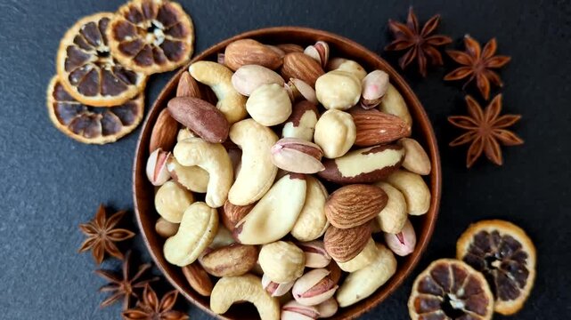 A mix of cashews, pistachios, almonds, brazil nuts, macadamia and hazelnuts as healthy food ingredients. Nuts as a food background for your design