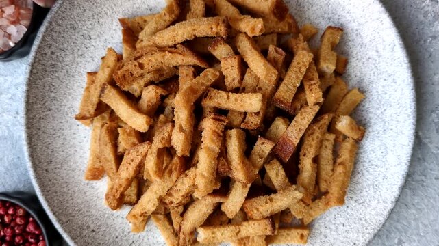Croutons or crackers made from rye bread with garlic, salt, and spices, a salad ingredient. Croutons with salt and garlic as a food background for your design