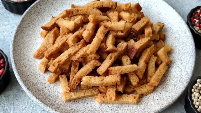 Croutons or crackers made from rye bread with garlic, salt, and spices, a salad ingredient. Croutons with salt and garlic as a food background for your design