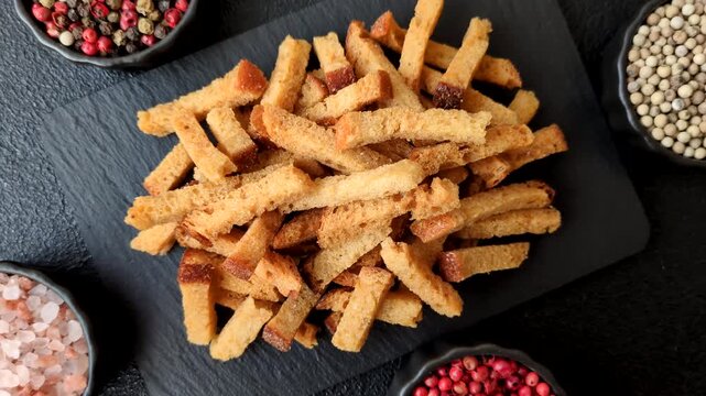 Croutons or crackers made from rye bread with garlic, salt, and spices, a salad ingredient. Croutons with salt and garlic as a food background for your design