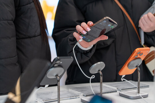 Showcase with smartphones in the electronics store. Buy a mobile phone. New Apple iPhones on the shelf of the store. A customer is choosing his next model. Minsk, Belarus - December 16, 2025