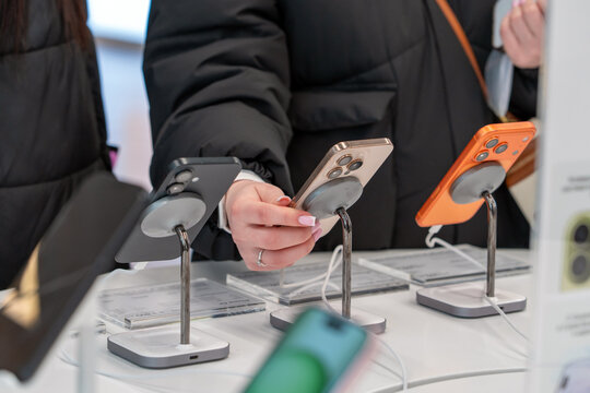 Showcase with smartphones in the electronics store. Buy a mobile phone. New Apple iPhones on the shelf of the store. A customer is choosing his next model. Minsk, Belarus - December 16, 2025
