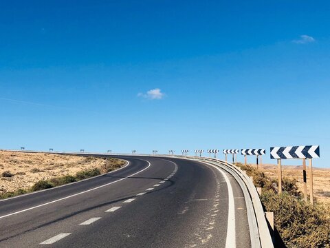 Chevron signs on a bend in the road, Fuerteventura, Las Palmas, Canary Islands, Spain