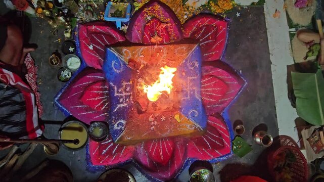 Hindu havan yajna ritual with sacred fire burning at the center of a decorated altar. The scene captures spiritual worship, offerings, and traditional religious ceremony. Ideal for themes of devotion