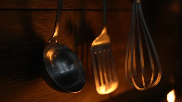 Kitchen Utensils Hanging in Dark Room.
