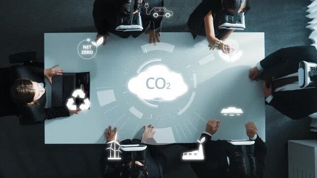 A corporate team collaborates in a modern workspace discussing climate change strategies using virtual reality tools to tackle carbon reduction and promote sustainability. Raster