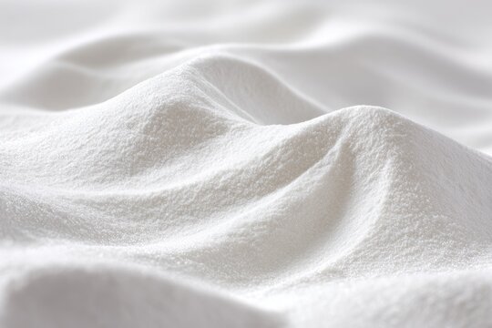 Abstract macro of fine arrowroot starch powder forming smooth dunes with subtle shadows