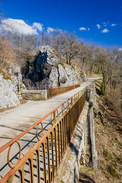 Pont du Diable road with cross on cliff, Doubs, FRANCE