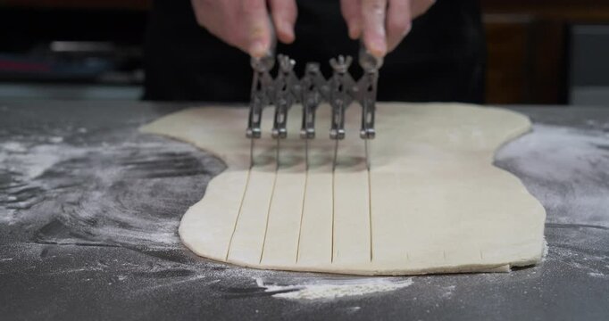 Cutting Puff Pastry Dough with Multi Wheel Pastry Cutter Close Up