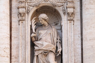 Fototapeta premium Statue of Saint Susanna on the Facade of the Santa Susanna alle Terme di Diocleziano Church in Rome, Italy