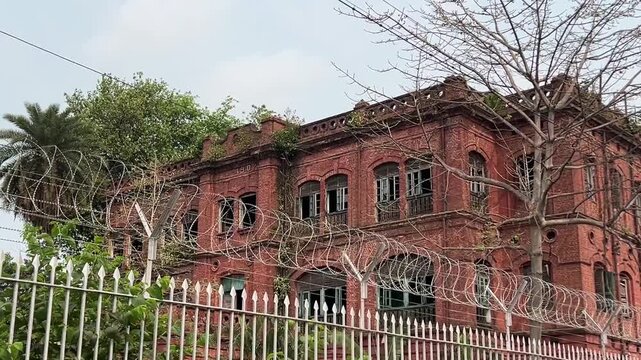 Option 1 (Heritage & Architectural): "Majestic British Raj era colonial architecture: A historic red brick heritage mansion with traditional arched windows in Bengal, India