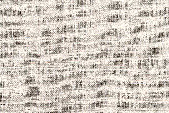 Minimal beige linen fabric texture with subtle burlap textile weave and soft neutral tones. Clean background for graphic design, branding, typography overlays and modern visual projects. AI-generated.