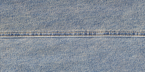 Blue jeans fabric with orange seam and texture