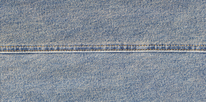 Blue jeans fabric with orange seam and texture