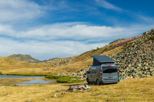 Camper van wild camping near mountain lake in Piedmont