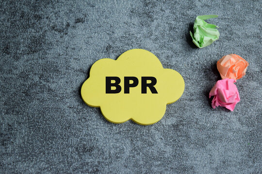 Concept of BPR - Business Process Re-engineering write on sticky notes isolated on Wooden Table.