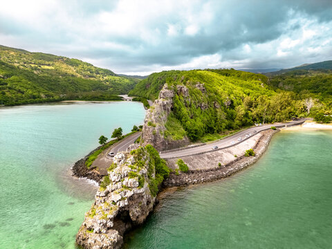Aerial view of Maconde Viewpoint along the coastal road of Mauritius, featuring dramatic cliffs, winding road and turquoise waters of the Indian Ocean.