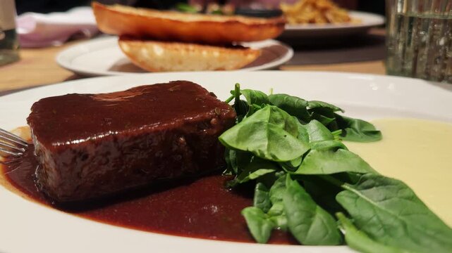 Oxtail with truffled Parmentier and a Montsant red wine sauce with with mashed potatoes and spinach. High quality 4k footage