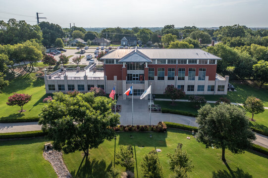 Aerial Drone View of Front Courtyard at Entrance to Rockwall, Texas Courthouse Building With Texas and American Flags