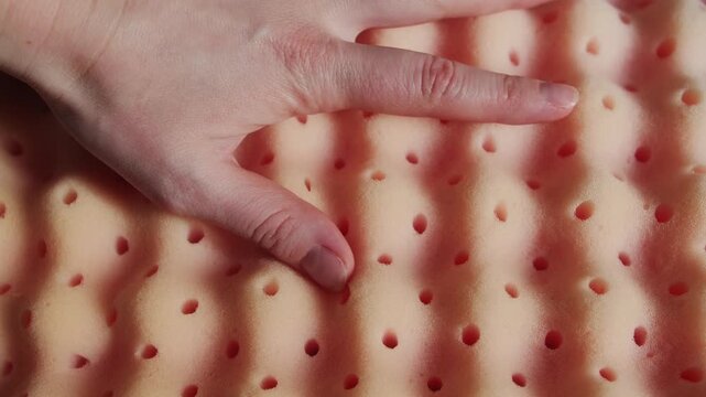 Hand pressing soft memory foam pillow, showing slow recovery and comfort ergonomic sleep concept. High quality 4k footage