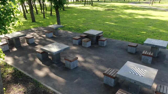 Drone lifting above chess tables in park