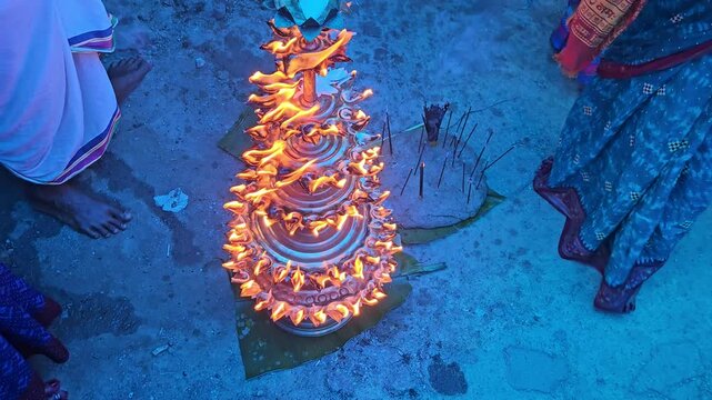Top view of women lighting diyas together during an Indian festival, creating a beautiful circle of glowing flames. Dushara, Vijayadashami, Diwali celebration, spirituality, community bonding, and fes