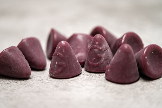 Traditional Belgian Cuberdon candies on a textured surface.