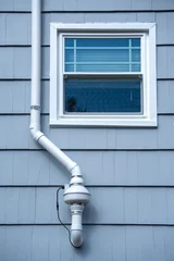 radon mitigation installed system outside the house © nd700
