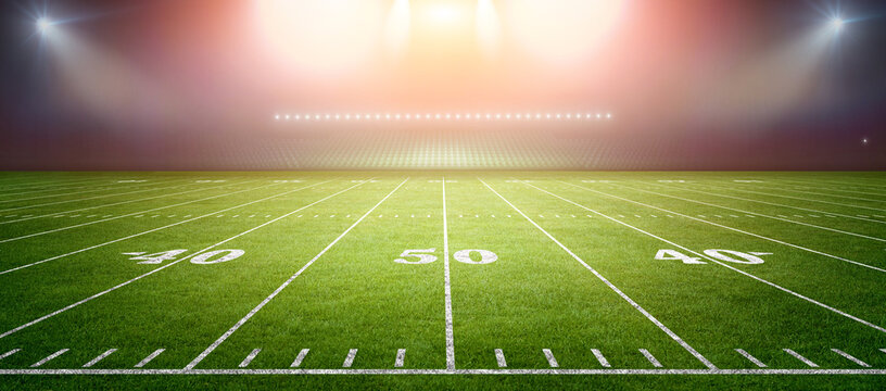 American football stadium field with bright lights.