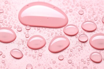 Fototapeta premium Many water drops on pink background, selective focus
