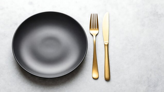 Gray plate with gold fork and knife on white marble table  table setting  dining utensils