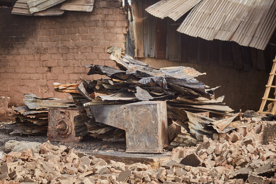 Kano, Nigeria - 27 January 2024: View of the charred remains of Fatima Market, Dakata, stand in stark contrast against the weathered brick and corrugated iron.