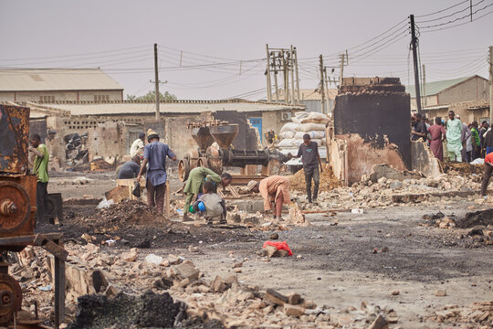 Kano, Nigeria - 27 January 2024: View of Dakata's Fatima market shows charred remains and people amidst the ashen landscape after a fire tragedy.