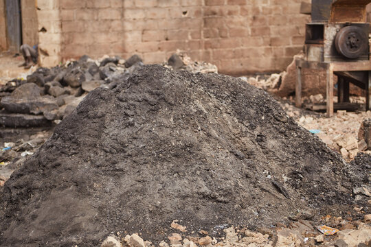 Kano, Nigeria - 27 January 2024: View of a dark pile contrasts against the weathered brick of Dakata fire service at Fatima market, Kano, Nigeria.